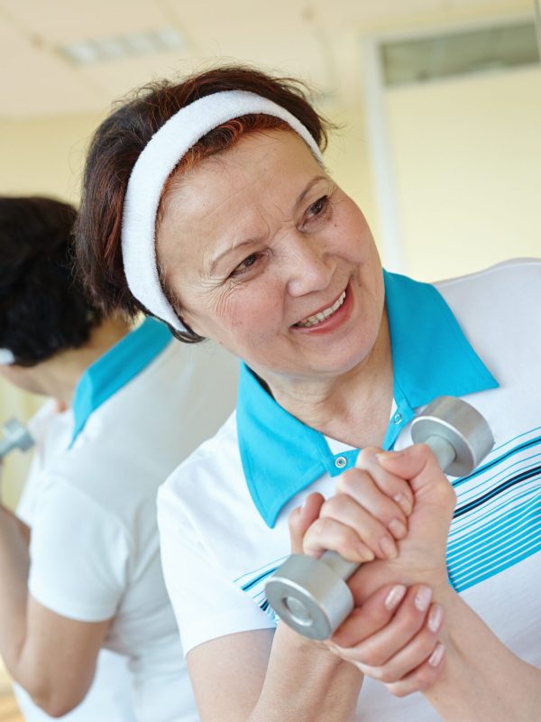 Portrait of aged women interacting in sport gym